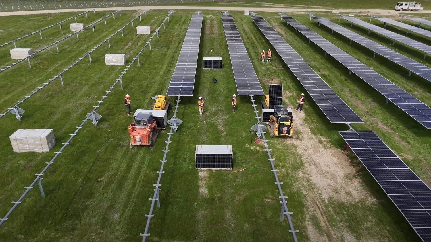 Aerial view of LUMIs and a crew installing solar modules on a utility-scale solar power plant